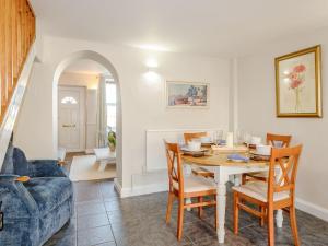 a dining room with a table and chairs at Jacks Cottage in Tinwell