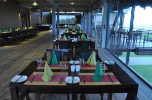 a dining room with tables and chairs in a building at Laya Safari Welfare Holiday Resort in Yala