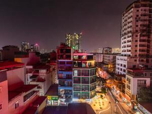 a view of a city at night with buildings at Madelise Max Hotel in Hanoi