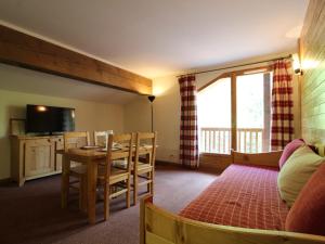 a living room with a table and a dining room at Appartement Lanslebourg-Mont-Cenis, 2 pièces, 4 personnes - FR-1-508-132 in Lanslebourg-Mont-Cenis