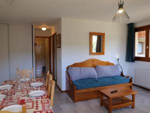 a bedroom with a bed and a dining room with a table at Appartement Aussois, 3 pièces, 6 personnes - FR-1-508-115 in Aussois