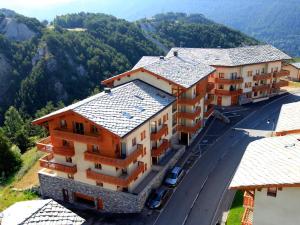 arial view of a building with mountains in the background at Appartement Aussois, 3 pièces, 6 personnes - FR-1-508-115 in Aussois