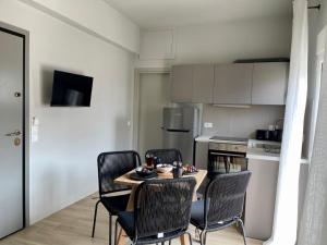 a kitchen with a table and chairs in a room at Campana’s Apartment in Argostoli