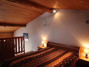 una camera con un letto in legno con due luci sopra di Appartement Aussois, 2 pièces, 4 personnes - FR-1-508-157 ad Aussois