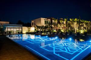 a view of a swimming pool at night at STORY Rabat in Rabat +29 photos
