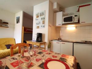 a kitchen with a table with a plate on it at Studio Lanslevillard, 1 pièce, 4 personnes - FR-1-508-194 in Lanslevillard