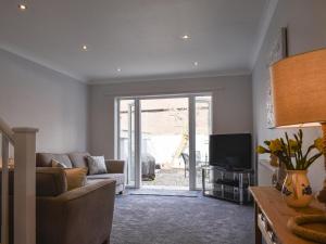 a living room with a couch and a tv at Pier View in Gorleston-on-Sea