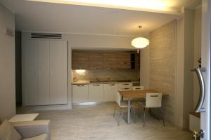 a kitchen with a table and a dining room at Nina Casa Vacanze in Finale Ligure +10 photos