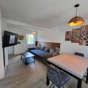 a living room with a couch and a table at Ferienwohnung NR1 in Großräschen