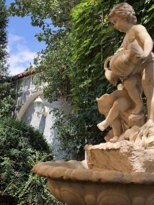 a statue of a boy on a fountain at Zolotoy Fazan in Mykolaiv