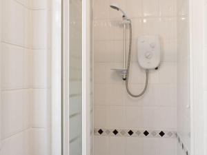a bathroom with a shower with a shower head at Little Gables in Verwood