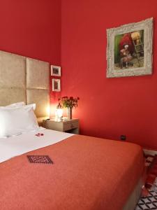 マラケシュにあるダル アル スルタンの赤い壁のベッドルーム(ベッド付)