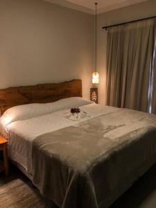 a bedroom with a bed with a flower on it at Pousada Villa Paraizo in Ribeirão Claro