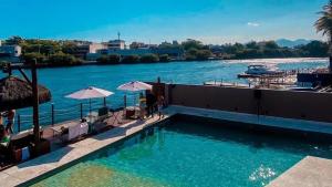 a swimming pool with a view of a river at Hotel Be Loft Lounge in Rio de Janeiro