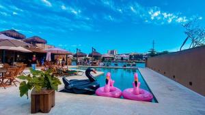 a swimming pool with pink flamingos in the water at Hotel Be Loft Lounge in Rio de Janeiro