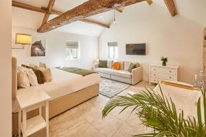 ein Schlafzimmer mit einem Bett und einer Couch in einem Zimmer in der Unterkunft The Irishman's Cottage in Yedingham