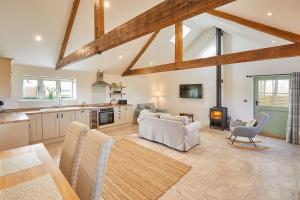 a kitchen and living room with wooden beams at The Irishman's Cottage in Yedingham