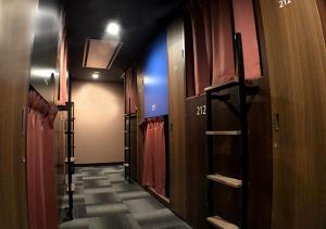 a hallway of a room with doors and curtains at ゲストハウス長岡街宿 in Nagaoka