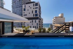 a swimming pool with a view of the city at Brown Beach House Tel-Aviv, a member of Brown Hotels in Tel Aviv