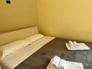a small bedroom with a bed with towels on it at LA PIGNA in Rome