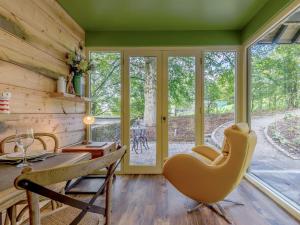 a dining room with a table and chairs and windows at Gadley Cottage - Uk31490 in Buxton