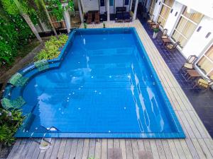 a large blue swimming pool on a patio at Nil Diya Beach Resort in Matara