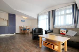 a living room with a couch and a table at Villa Karina by Rujana in Göhren