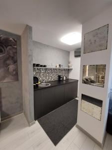 a kitchen with a black counter top in a room at DAVID's studio in Timişoara
