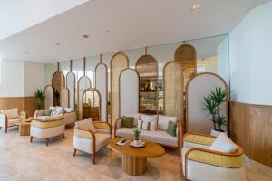 a lobby with chairs and tables and mirrors at Mirada Exclusive Bodrum in Bodrum City
