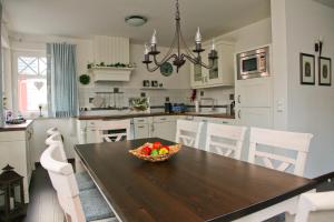 a kitchen with a table with a bowl of fruit on it at "Zingster Traum 2" Müggenburger Weg 36 a in Groß Kirr