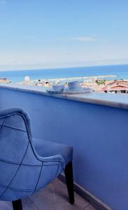 a blue bar with a chair and a view of the ocean at Alya Suite Rezidans in Trabzon