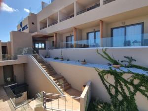 a view of a building with stairs and plants at Meliti Hotel (Adults Only) in Agios Nikolaos