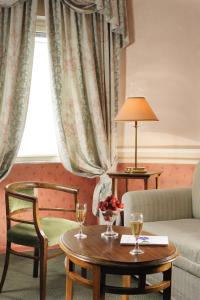 a living room with a table and a couch at Hotel Alexandra in Rome