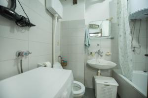 a small bathroom with a toilet and a sink at Apartman Vukcevic in Podgorica