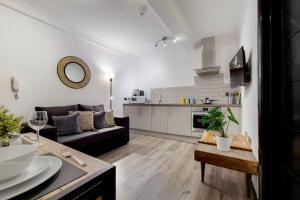 a living room with a couch and a table at Langdon Brooks Apartments in London