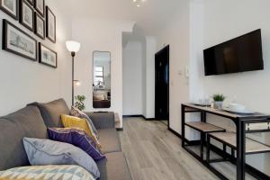 a living room with a couch and a table at Langdon Brooks Apartments in London