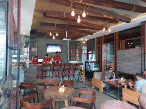 a restaurant with people sitting at tables and a bar at Rodeos Inn in Kathmandu