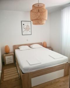 ein Schlafzimmer mit einem großen weißen Bett in einem Zimmer in der Unterkunft Hello Sunshine - Apartment on the Beach in Zubovići