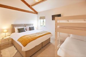 a bedroom with a bed and a bunk bed at Wold's View Cottage in Yedingham +3 photos