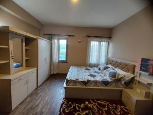 a small bedroom with a bed and a window at Nepal christian guest house in Pātan