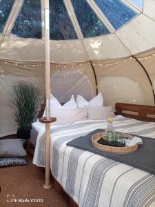 a bedroom with a bed in a tent at Glamping Altes Pastorat in Barmstedt