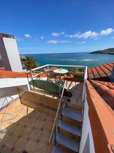 a balcony with a table and chairs and the ocean at Mundaka Vista Mar L-BI-52 in Mundaka