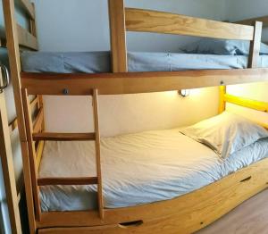 a couple of bunk beds in a room at Gourette studio près des pistes, Résidence Val Soleil, 256 Gourette Nord, rue de Tortes in Gourette