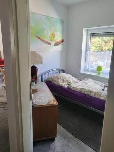 a bedroom with two beds and a window at Ferienwohnung Markranstädt in Markranstädt