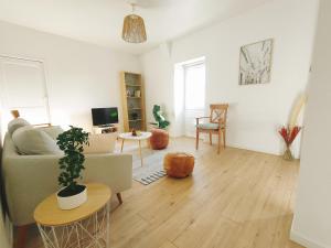 a living room with a couch and a table at Quiet & Cosy near Loire River & Tramway in Nantes