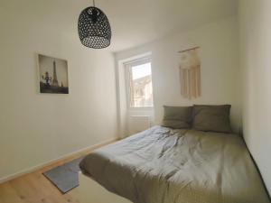 a bedroom with a bed and a window at Quiet & Cosy near Loire River & Tramway in Nantes