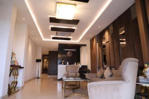 a lobby with couches and a bar in a building at Paras inn in Gurgaon