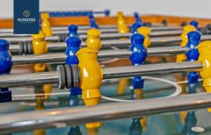 a row of yellow and blue rubber controllers in a gym at THE PENTHOUSE, Spacious, Stunning Views, Foosball Table, 3 Large Rooms, Central Location, River Front, Tay Bridge, V&A, 2 mins to Train Station, City Centre, Lift Access, Parking, WiFi, Mid-Stay Rates Available by SUNRISE SHORT LETS in Dundee