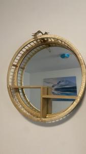 a mirror with a wooden frame on a wall at Bv Comfy Studio At Deighton Huddersfield in Huddersfield