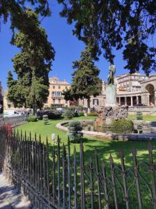 a statue in front of a park with a fountain at Corfu Old Town Gregory in Corfu Town